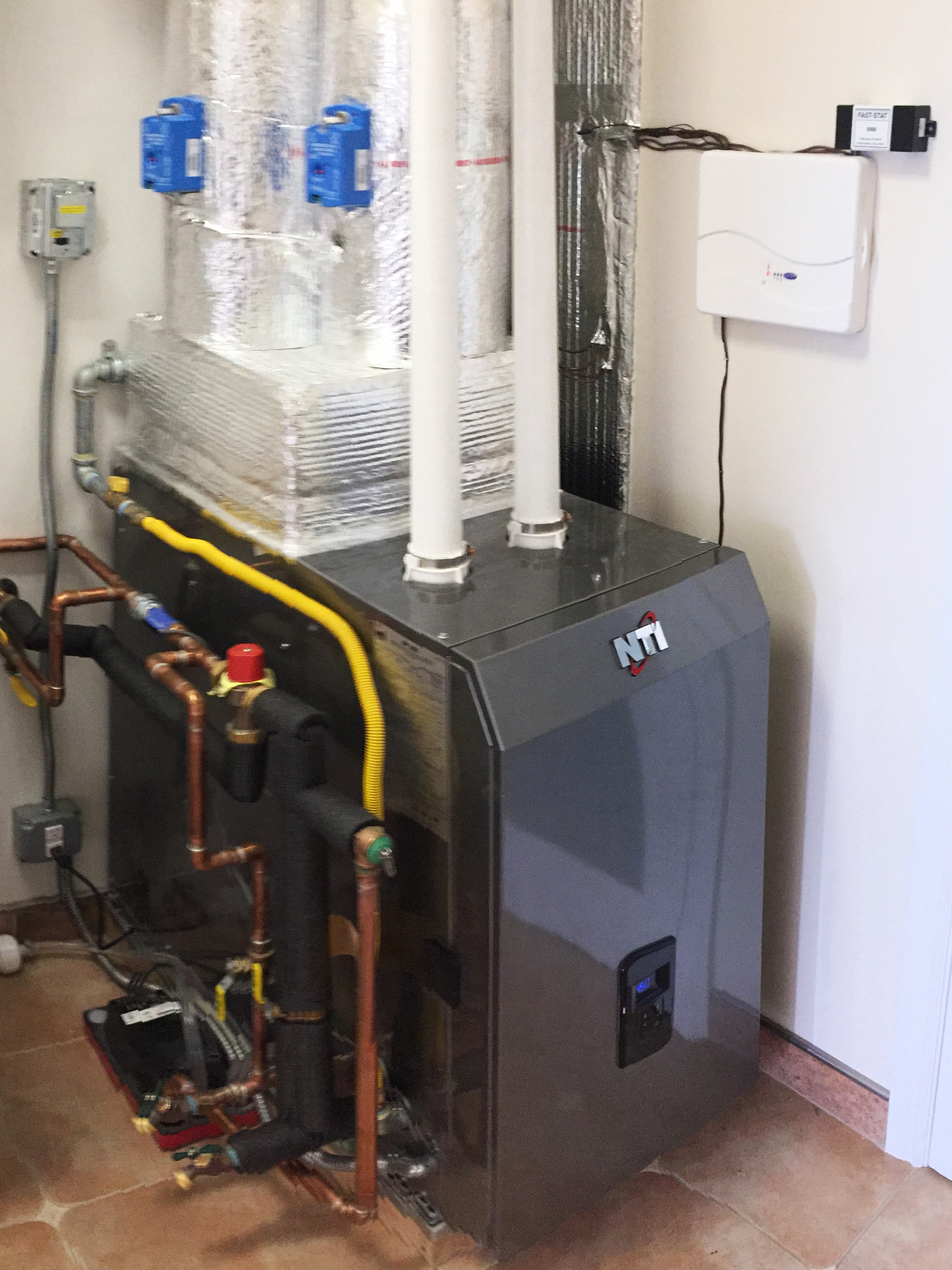 Combi tankless water heater and hot water fan coil.