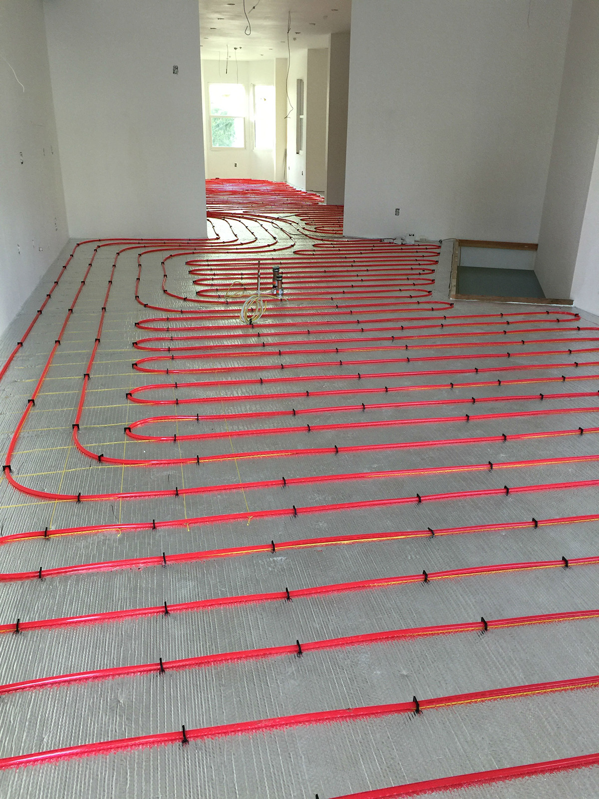 Radiant floor heating in slab over subfloor